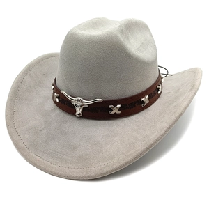 Detail of grey suede cowboy hat featuring embossed leather band and silver bull head icon