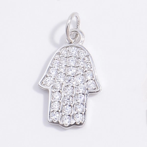 Macro shot of a Hamsa hand pendant with S925 silver finish and shimmering zircon stones
