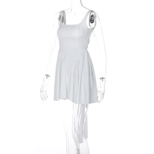 Close-up of white backless mini dress with ruffled hem and sleek A-line silhouette