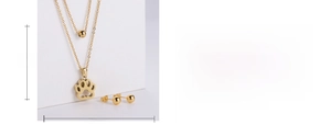 Detail showing gold double-layer chain necklace with hollow dog paw print pendant