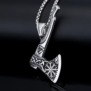 Macro view of Viking axe pendant with intricate Celtic knots and Valknut symbols