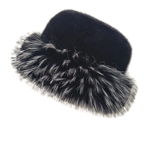 Detailed view of thick faux mink fur bucket hat with grey-white tips on black fur