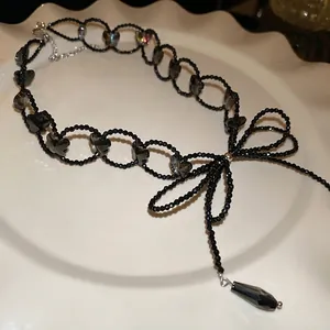 Elegant black beaded choker necklace featuring grey glass butterfly charms and bow pendant