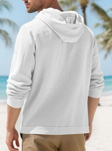 Back view detail of white hooded linen jacket showing textured cotton fabric and ribbed hem