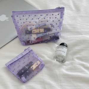 Detailed view of flocked mesh makeup bags with heart patterns in light purple