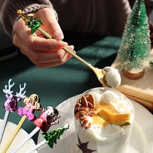 Golden Christmas dessert spoon set featuring cartoon Santa and tree charms for festive dining