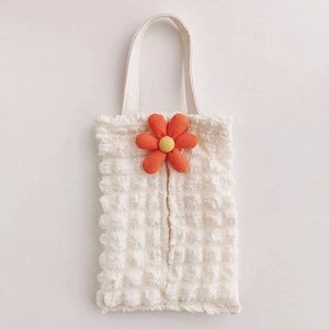 Close-up of white bubble texture fabric with orange flower on car tissue holder