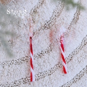 Set of two red and white spiral candy cane lollipop ornaments on white plush background