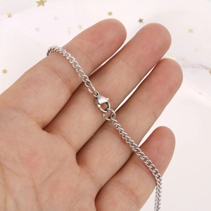 Silver stainless steel curb chain necklace with secure lobster clasp shown in hand
