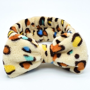 Leopard print coral fleece headband with a decorative bow for washing face and makeup