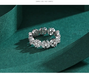 Detail view of a sterling silver ring featuring marquise-cut clear zircon floral clusters