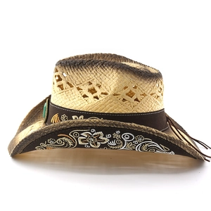Detail of straw cowboy hat with floral embroidery, turquoise bead and hollow weave