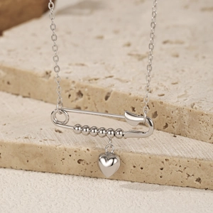 Minimalist S925 sterling silver safety pin necklace with heart pendant on stone decor