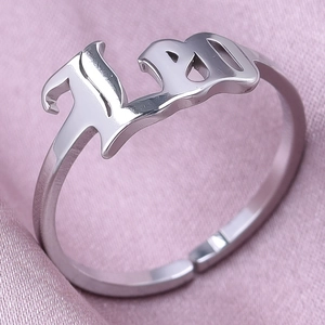 Detailed macro view of the silver Leo zodiac gothic style adjustable ring on silk fabric