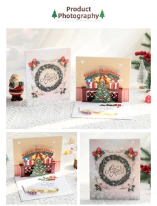 Detail showing 3D pop-up Christmas card with festive fireplace and tree scenes