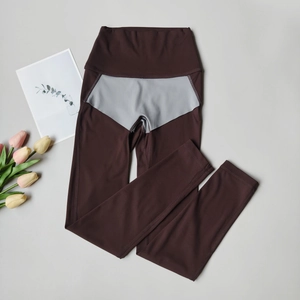 Detail of high-waisted seamless yoga leggings featuring a two-tone contrast panel design