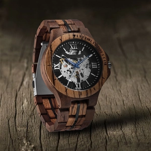 Macro side view of hollow mechanical movement with walnut wood casing and blue hands