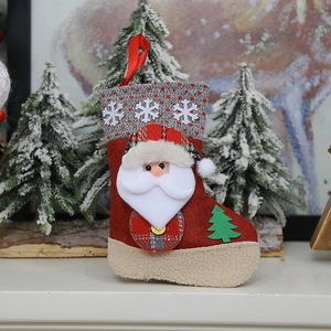 Red felt Christmas stocking with plush Santa Claus and snowflake knit detail