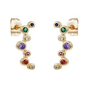 Macro detail of curved gold studs with multi-colored sparkling round zircon stones