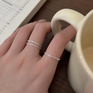 Close-up of three 925 sterling silver heart-shaped open rings worn on a hand