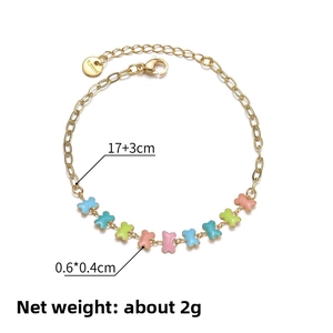 Detail of 14K gold plated stainless steel bracelet with colorful oil-dripped bone charms