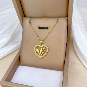 Elegant gold heart antler necklace with sparkling zircon pavé on a white silk display