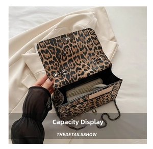 Internal capacity of leopard print chain bag showing wallet and mirror storage