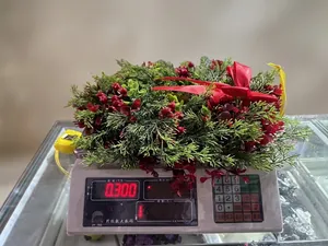 Detailed scale view showing the 0.3kg weight of the green Christmas wreath with red bow