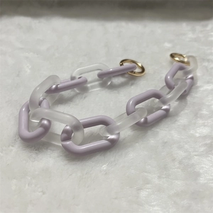 Detail of light purple and frosted acrylic link chain with gold metal round clasps