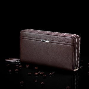 Detail of coffee brown leather wallet with double zippers and lychee grain texture
