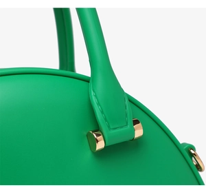 Close-up of matte green jelly bag featuring durable handle with premium gold hardware