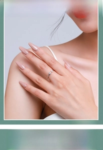 Close-up of adjustable silver ring with two square-cut zircons on a model's hand