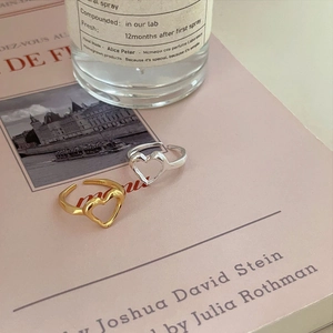 Elegant S925 sterling silver heart open rings in gold and silver finish on a book