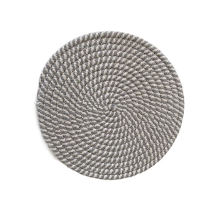 Close-up of the spiral texture of a gray and cream woven heat-resistant cotton coaster