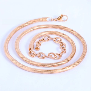 Detailed view of golden snake bone chain necklace with lobster clasp and extension