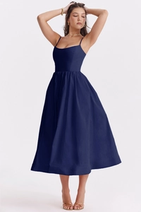 Detailed view of elegant navy blue backless maxi dress with a fitted waist and flowing hem