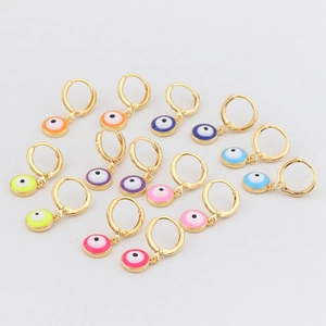 Detailed close-up of gold hoop earrings featuring vibrant colorful enamel evil eye charms