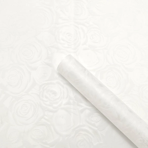 Detailed macro view of white translucent flower wrapping paper with rose floral texture