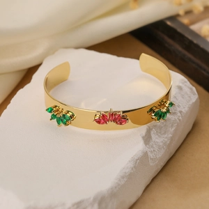 Gold open cuff bracelet with red and green marquise zircons on artistic stone base