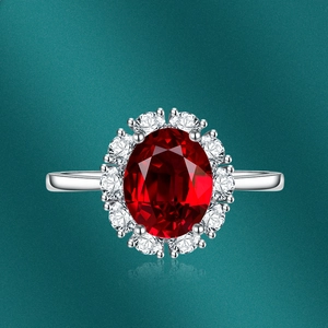 Macro detail of oval ruby ring with shimmering halo diamonds and polished silver band