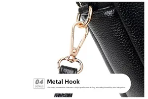 Close-up of durable golden metal hooks on a black lychee texture leather crossbody bag