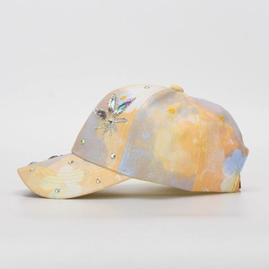 Detailed view of colorful tie-dye kids baseball cap with sparkling rhinestone flowers