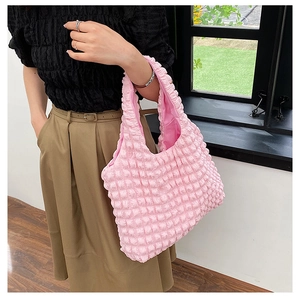 Detail view of pink popcorn texture tote bag showing its unique puffy 3D fabric and size