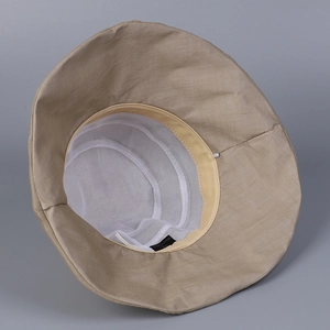 Detail of breathable white mesh lining and sweatband inside the ramie bucket sun hat