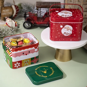 Detail of Christmas tin gift box with metal handle and festive holiday scene patterns