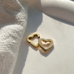Detailed view of heart-shaped gold stainless steel jewelry connectors for DIY necklaces