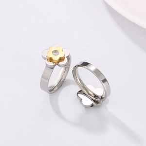 Detail of silver and gold flower ring with clear cubic zirconia in a polished finish