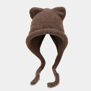 Close-up of knit cat ear hat featuring thick mixed-color yarn and braided earflaps