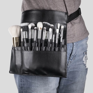 Detail of professional black makeup brush waist bag with multiple slots and pockets