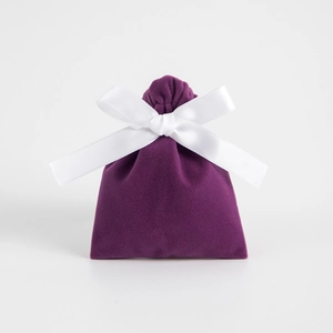 Elegant deep purple velvet jewelry pouch with a contrasting white silk ribbon bow tie